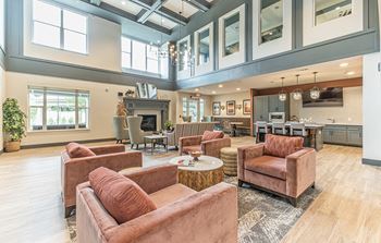 Resident lounge with kitchen, dining space and fireplace
